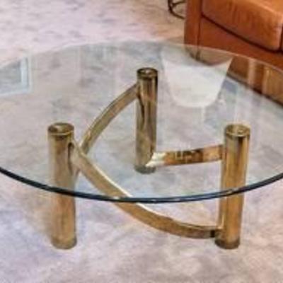 Mid Century Modern Round Brass and Glass Coffee Table.

Measures 44” in diameter and 16” high.