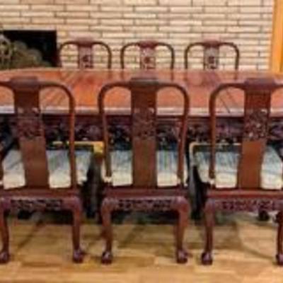 Gorgeous Carved Rosewood Dining Set Inlaid with Mother of Pearl Dragon Motif. Includes seating for eight and two additional leaves.

The...