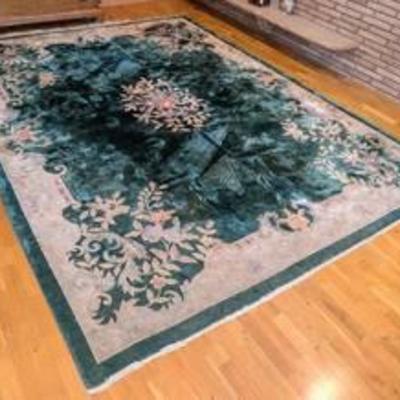 Large Chinese Wool Floral Area Rug.

There is some wear including to the fringes. Please see photos for additional details.

Measures...