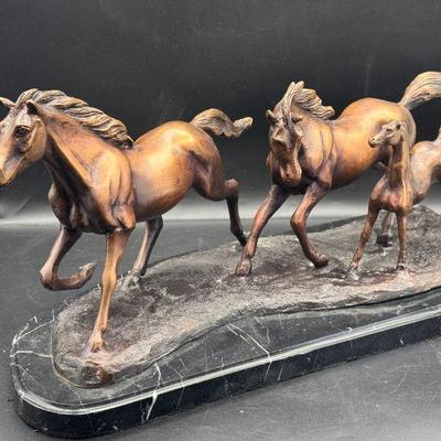Metal Horses On Marble Slab
