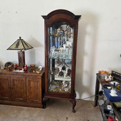 Vintage curio cabinet with assorted figurines