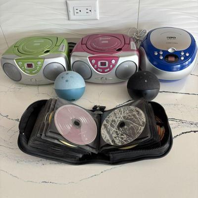 Lot #44 - Audio Equipment Lot - Sylvania Boomboxes, Naxa CD Player, 2 Amazon Echo Dots, & Large CD Lot
