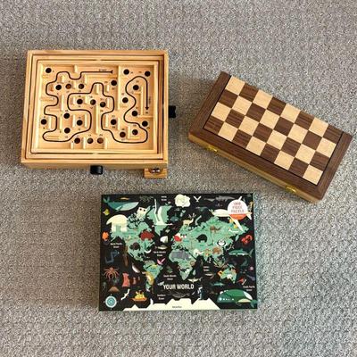 Lot #143 - Variety Game Lot - Labyrinth Game, Wooden Chess Set, and Mudpuppy World Map Puzzle.