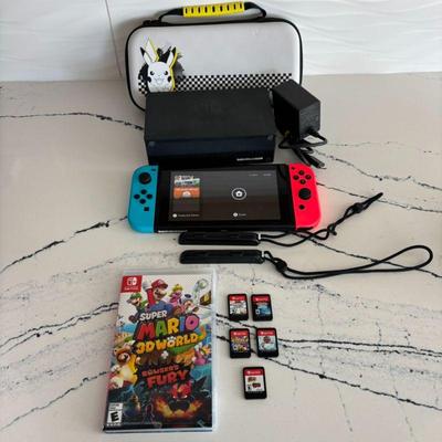Lot #46 - Nintendo Switch Console Bundle - Includes Accessories, Dock, Pokemon Case, & Games- Mario, Pokemon, & More .