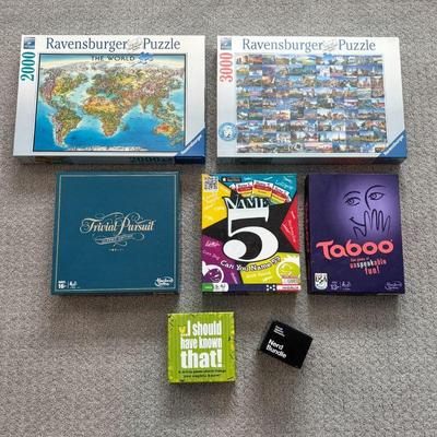 Lot #144 - Games & Ravensburger Puzzle Lot - Cards Against Humanity, Taboo, Trivial Pursuit, and More