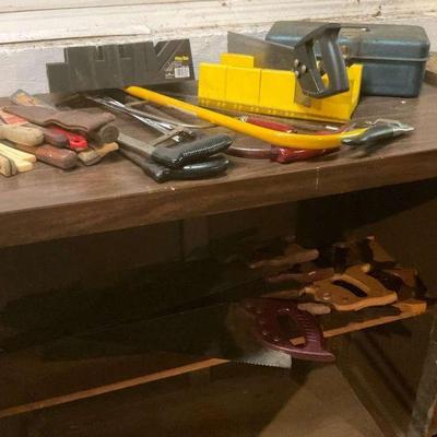 Collection of vintage and modern hand tools and saws