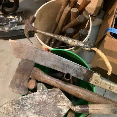 Lots of hammers mallets, and axes in buckets