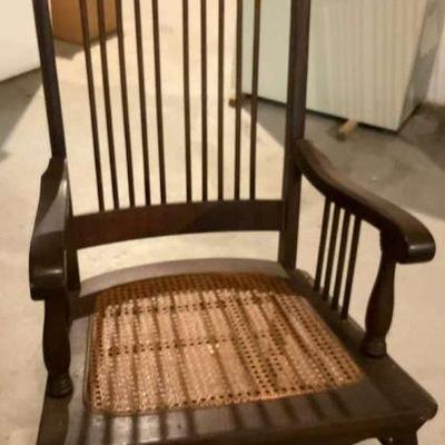 Vintage wooden rocking chair with cane seat