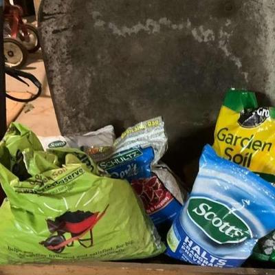 Wheelbarrow and gardening supplies soil fertilizer, and more