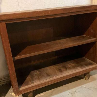 Rustic wooden shelf or work cabinet on caster legs
