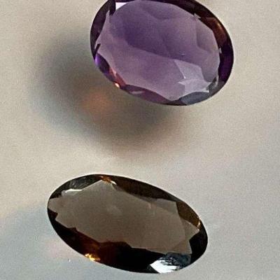 Faceted amethyst and smoky quartz gemstones