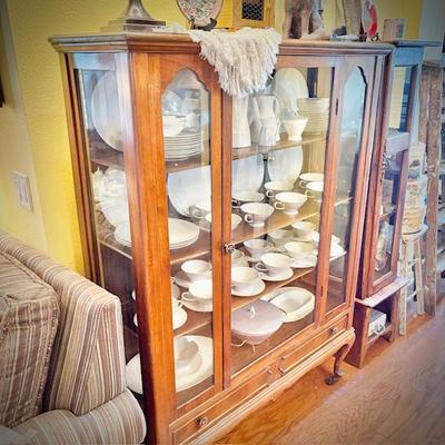 Antique glass china cabinet with bottom drawer, filled with MCM Rosenthal-Continental "Crystalline Blue" china set