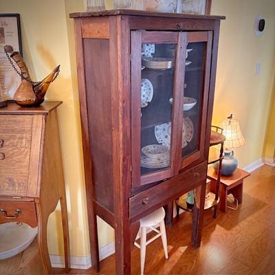 Antique pie safe with bottom drawer. Holding Churchill "Finlandia" china set.