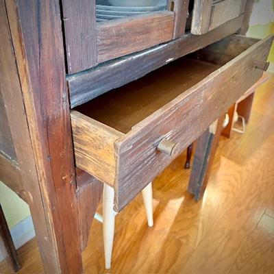 Antique pie safe with bottom drawer. Holding Churchill "Finlandia" china set.
