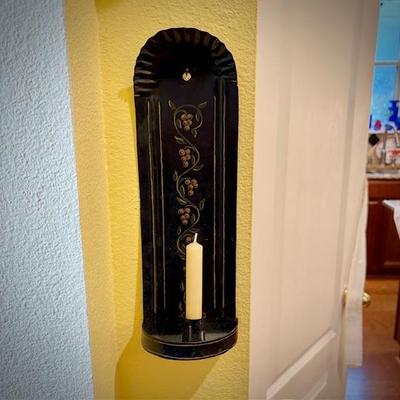 One of two black tin tole-painted candle sconces