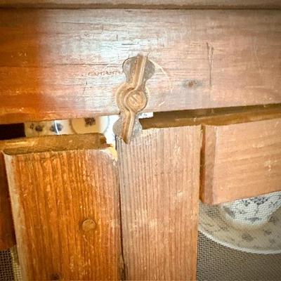 Antique pie safe with bottom drawer. Holding Churchill "Finlandia" china set.