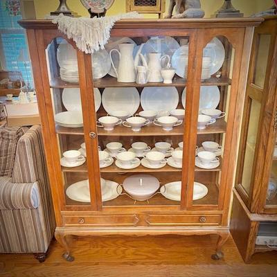 Antique glass china cabinet with bottom drawer, filled with MCM Rosenthal-Continental "Crystalline Blue" china set