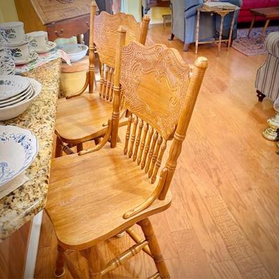 Three swivel oak bar stools (3rd is in garage)