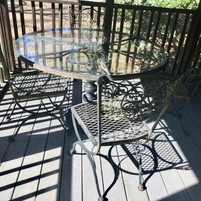 metal and glass 47" table and four chairs 395