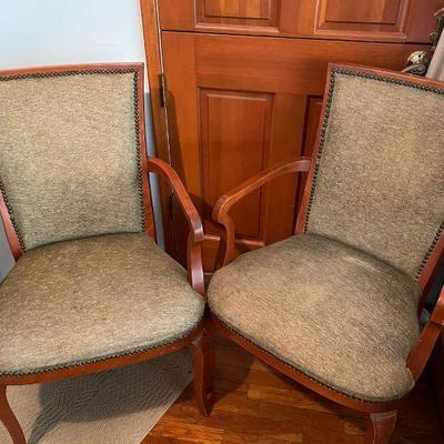 A pair of upholstered wood accent chairs