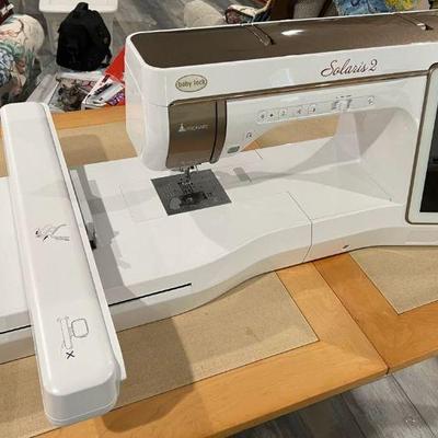Baby Lock Solaris 2 sewing machine with built-in IQ Visionary™ projector, which displays stitches and embroidery designs directly on the...