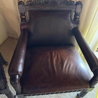There are 4 of these leather hand carved chairs!