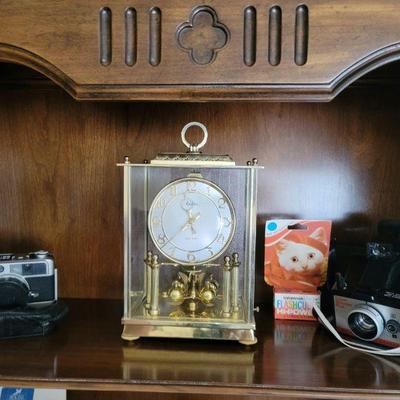 A cabinet full of picture making and a clock to help you Spring Forward 