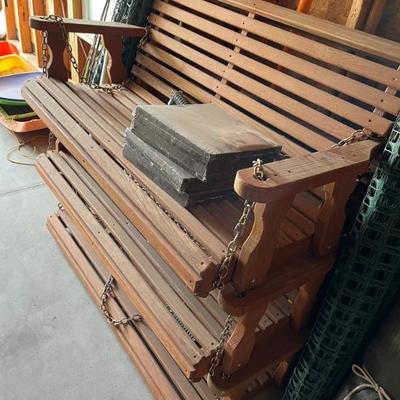 3 identical, swinging benches stacked on one another 