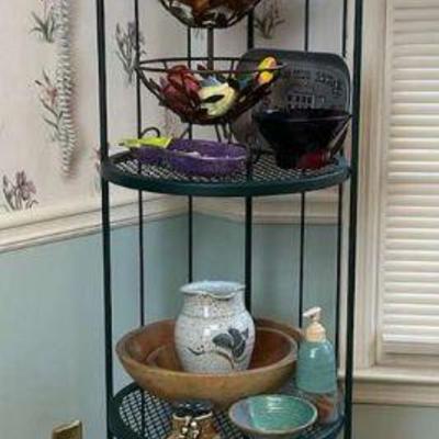 Metal corner shelf with home decor items