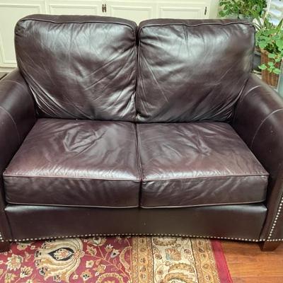 Dark maroon leather sofa with studs 60”
