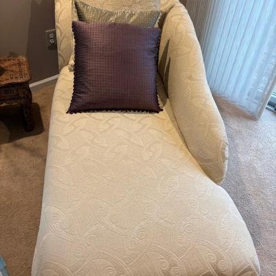 Cream-colored jacquard divan.