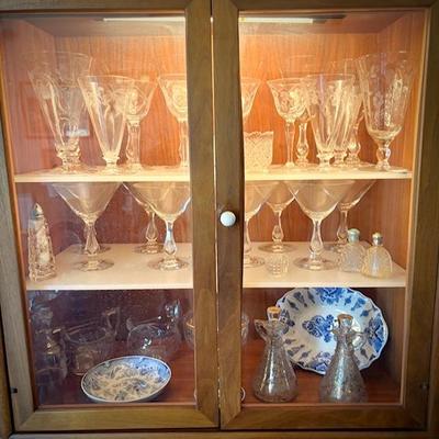 Drexel MCM china cabinet c. 1960. Lighted top with glass doors. Bottom has pullout shelf and drawers and cupboard.