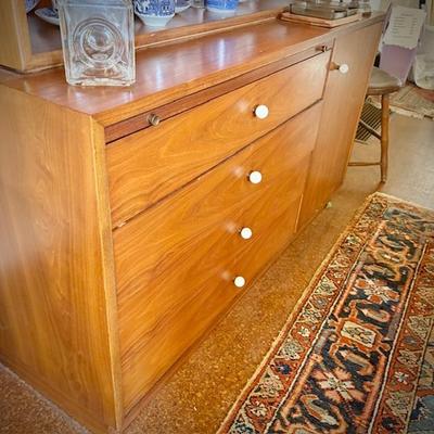 Drexel MCM china cabinet c. 1960. Lighted top with glass doors. Bottom has pullout shelf and drawers and cupboard.