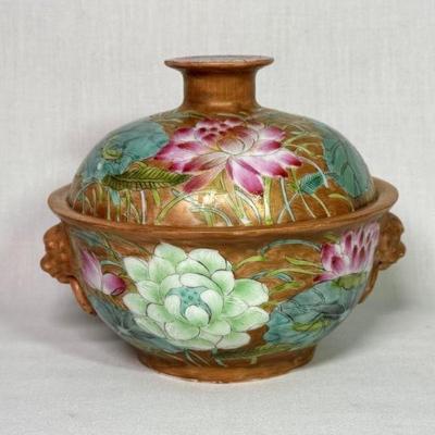 Lidded Lotus Dish, China, early 20th century, with mock lion and ring handles, the sides and cover decorated with lotus leaves, buds, and...