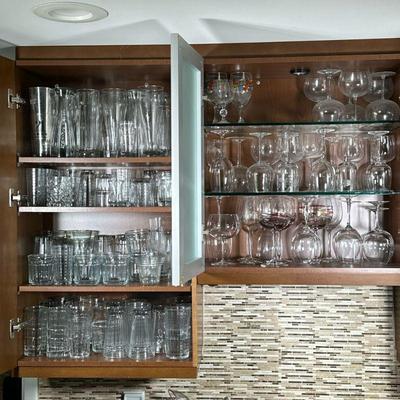 CABINET OF GLASSWARE | Large cabinets full of mixed glassware including; water glasses, wine glasses, beer glasses, rocks glasses and...