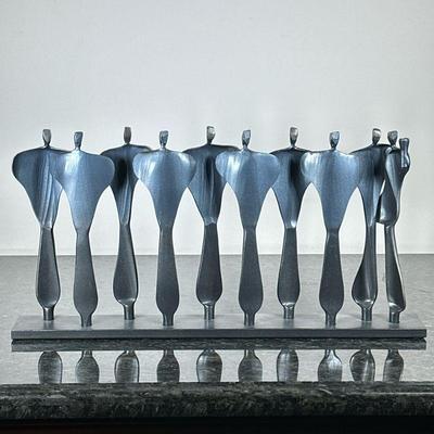 BORIS KRAMER (CANADA 1969-) MENORAH | Boris Kramer forged steel Menorah featuring abstract figures, signed on corner. - h. 10 x w. 19 x...