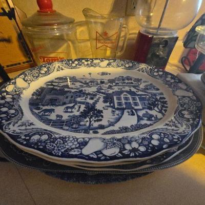 Vintage Blue and White Plates
•	A stack of vintage blue and white decorative plates, each adorned with intricate scenes of rural life....