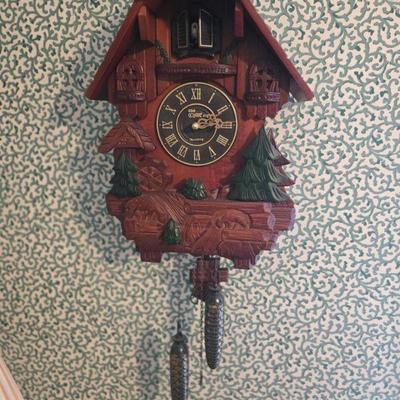 Vintage Coo-coo Clock
-  This beautifully carved wooden cuckoo clock features a detailed forest design with pine trees and wildlife. The...
