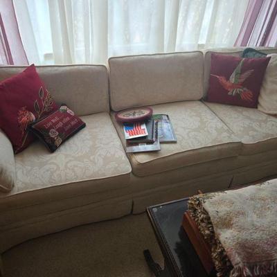Cozy Couch with Decorative Cushions
•	Description: Cozy up in style with this plush, light-colored fabric sofa, complete with beautifully...