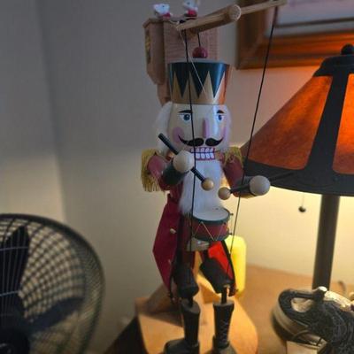  Nutcracker with Pulling Strings and Figurine Display
•	 A festive wooden nutcracker, meticulously crafted, holding a set of tiny white...