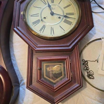 Vintage Regulator Wall Clock 
- Classic wooden regulator wall clock with Roman numerals and glass pendulum door. Some parts shown...