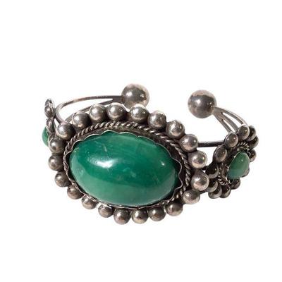 JAKA217 Jade Cuff Bracelet	Made in Mexico, Jade cuff bracelet. Jade mounds possibly sterling but can't confirm.
