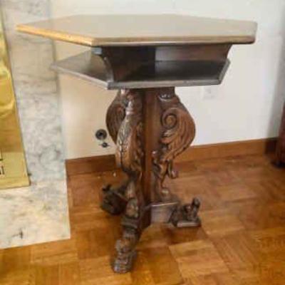 JAKA818 Antique Side Table	Antique wooden hexagonal tripod-legged side table. Legs have a carved eagle and stylized scroll design, table...