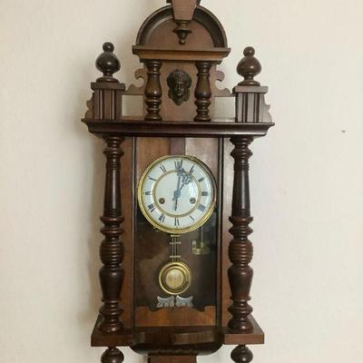 JAKA805 Antique European Wall Clock	Wood clock has beautiful carved detail. Wind up mechanism but key is not included. When wound, clock...
