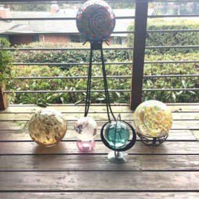 JAKA811 Glass Ball Outdoor Decor	Assortment of outdoor decor in the form of colored glass balls, and glass mosaic of the sun in a ball.
