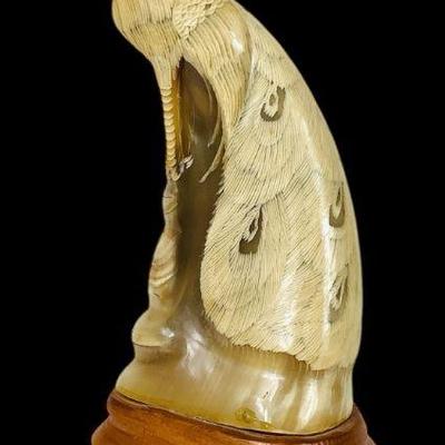 JAKA209 Vintage Hand Carved Peacock	Appears to be buffalo horn, wooden base and unsigned.
