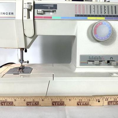 JAKA204 Touch & Sew Singer Sewing Machine With Accessories	inger sewing machine with lots of different color spools of threads and...