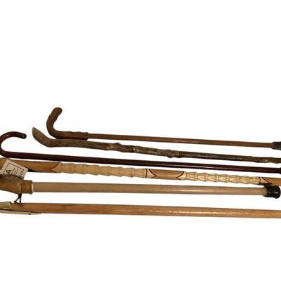 JAKA804 Canes And Walking Sticks #6	Six walking sticks and canes. Notable inclusions are a Jamacain walking stick hand carved with a...