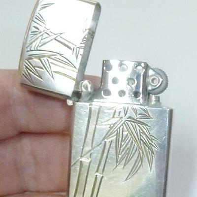 Sale Photo Thumbnail #56: Sterling Silver cigarette lighter, works