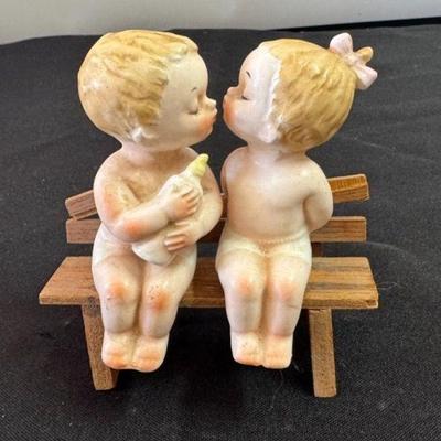 Vintage Babies Kissing Salt And Pepper Shakers On A Bench
